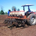 Farmers using a tractor to farm the land