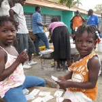 Children playing cards in a child friendly space in Jacmel.