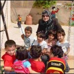 Zeinab plays with the children attending her kindergarten in Sakhra, Jordan.
