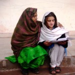 A student reads to Gul after school in Dharian Bambian.