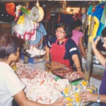 Stall owner Angelina Bulos at the Muntinlupa Market is pleased that both vendors and customers now have a cleaner market thanks 