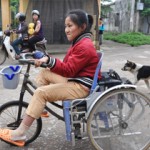 Pham Thi Bich Ngoc rides the modifi ed wheelchair to get her out into the community.