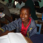 Lovemore studies at night in the streets. He hopes for a Presbyterian Children’s Club scholarship for boarding school. 