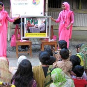 A courtyard meeting conducted by the Social Marketing Company trains expectant and new mothers on newborn care.