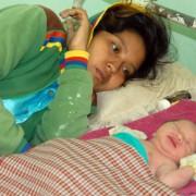 A mother with her newborn at a health center for post-partum care.