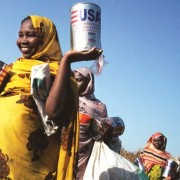USAID foodstuffs are distributed through the World Food Program to internally displaced persons in Muhadjeria, Darfur.
