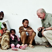 Anthony Lake converses with a family outside a health center in Ethiopia in June 2009, before taking up his post with UNICEF, as