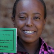 Asilya Gemmal, 14, of Gure Tebeno Union, proudly displays her land certificate obtained from the Ethiopian Government with USAID