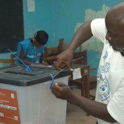 A polling station worker opens the ballot box prior to counting votes. Independent observers concluded that the 2011 elections w