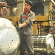 Employees at the Sonha Corporation produce stainless steel water tanks in Hanoi. 