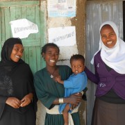 Enanit Metiku holds her son, Tazen, flanked by Belaynesh Fentie, left, and Tegegnech Tsehay, health extension workers.