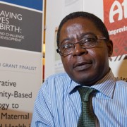 Christopher Mfornyam, of Africare, mans his organization's display at USAID's third Saving Lives at Birth event.