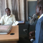 Misozi Banda, left, reviews referrals for the day with Martin Banda,