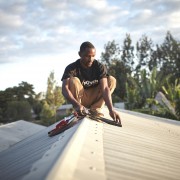 A local Off-Grid:Electric employee installs a solar home system in Tanzania.