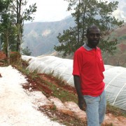 Michel Dorlean stands in front of his flower growers’ association’s greenhouses in Furcy.