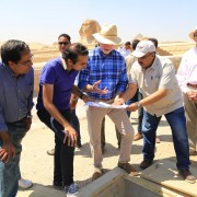 U.S. Ambassador Beecroft and others view a draining pump that protects the Sphinx from groundwater