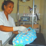 A health worker applies chlorhexidine to the cord of a newborn baby born in the Banke district health facility