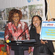 USAID-funded Tsela Kgopo project presents the “Desk Buddy,” a solar-powered portable desk and light, to Botswana's Assistant