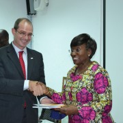 USAID Country Director shakes hand with Ivorian Minister of Health as he remits the new healthcare policy