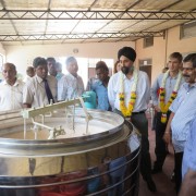 USAID Deputy Assistant Administrator Manpreet Anand examines rice flour processing machinery at Sivanarul Vocational Training an
