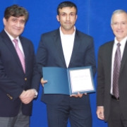 Abdul Raziq Samadi (L), Head of DABS, and William Hammink (R), USAID Mission Director recognized the work of Ehsan Khaibar.