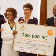 U.S. Ambassador Patricia Haslach presents an award to Rahel Moges, the winner of an innovation business plan competition.