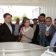 Local residents join USAID staff to tour the facility
