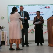 USAID representative Gary Robbins presents awards to the new graduates.