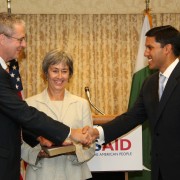 Jonathan Conly and Administrator Shah shake hands following the swearing-in