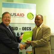Mission Director Chris Cushing , officially hands over RRACC Demonstration project documents to Alvin DaBreo, Minister with resp