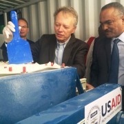 USAID Ethiopia Mission Director Dennis Weller and State Minister Kebede Gerba observe the process for making the fluoride filter