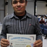 A young man poses with his new certificate