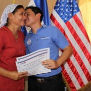 Nain, one of the program beneficiaries, kisses his mother after the graduation