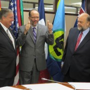 Elated CARICOM Secretary General Ambassador Irwin LaRocque gives a thumbs up following the signing