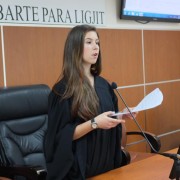 A high school student dressed in a judge's robe participates in a ‘mock trial on domestic violence’