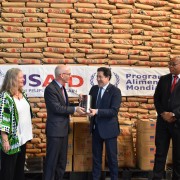 U.S. Ambassador James Swan (second left) handed a symbol of U.S. food assistance to WFP Country Representative Pablo Recalde. 