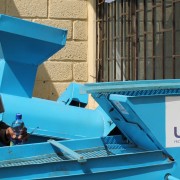 A smallholder farmer examines the new maize seed cleaning machine, which will help him improve the quality and potentially the p