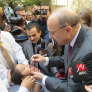 Egyptian Minister of Health and Population Dr. Adel Al Adawy vaccinates a child against polio.