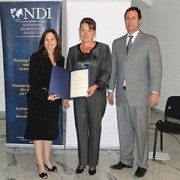 USAID/Kosovo Mission Director Maureen A. Shauket (left) joined by NDI Regional Director Rob Benjamin (right) presents graduation
