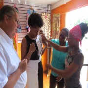 Tasnica Lovell of  'Angels Couture'  discusses  her business and merchandise  with USAID Mission Director, Chris Cushing