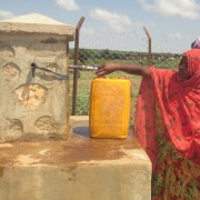 Women fill jerrycans at a water point in the Somali Region.