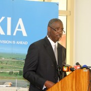 A man stands behind a podium delivering a speech