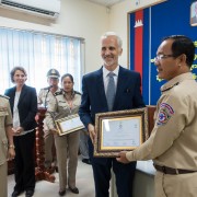 Sean Callahan, USAID Deputy Mission Director, presents Certificates of Completion to Police Trainees