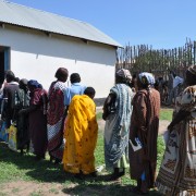 Program participants stand in line to receive a cash transfer for food outside a training facility in Juba, South Sudan