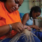 Orlanda and her daughter work at hand weaving at their home in the town of Bucaramanga, where they escaped to after being uproot