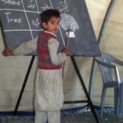 This student at a school in the Mehra Camp for displaced earthquake survivors in Pakistan leads his classmates in an English lan