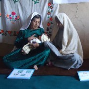 A community health worker provides basic information on newborn care to Miriam from Bamyan Province.