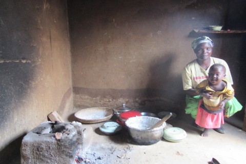 Merifa Muvwera and daughter, Loveness, portioning nsima, Malawi’s staple food, after preparing the meal on their improved cookst