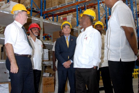 U.S. and Ghana officials tour new warehouse.