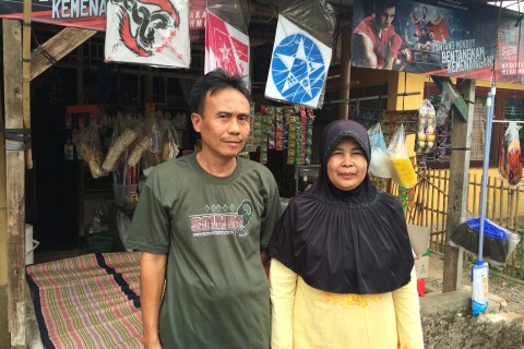 Nurita and her husband in front of their business